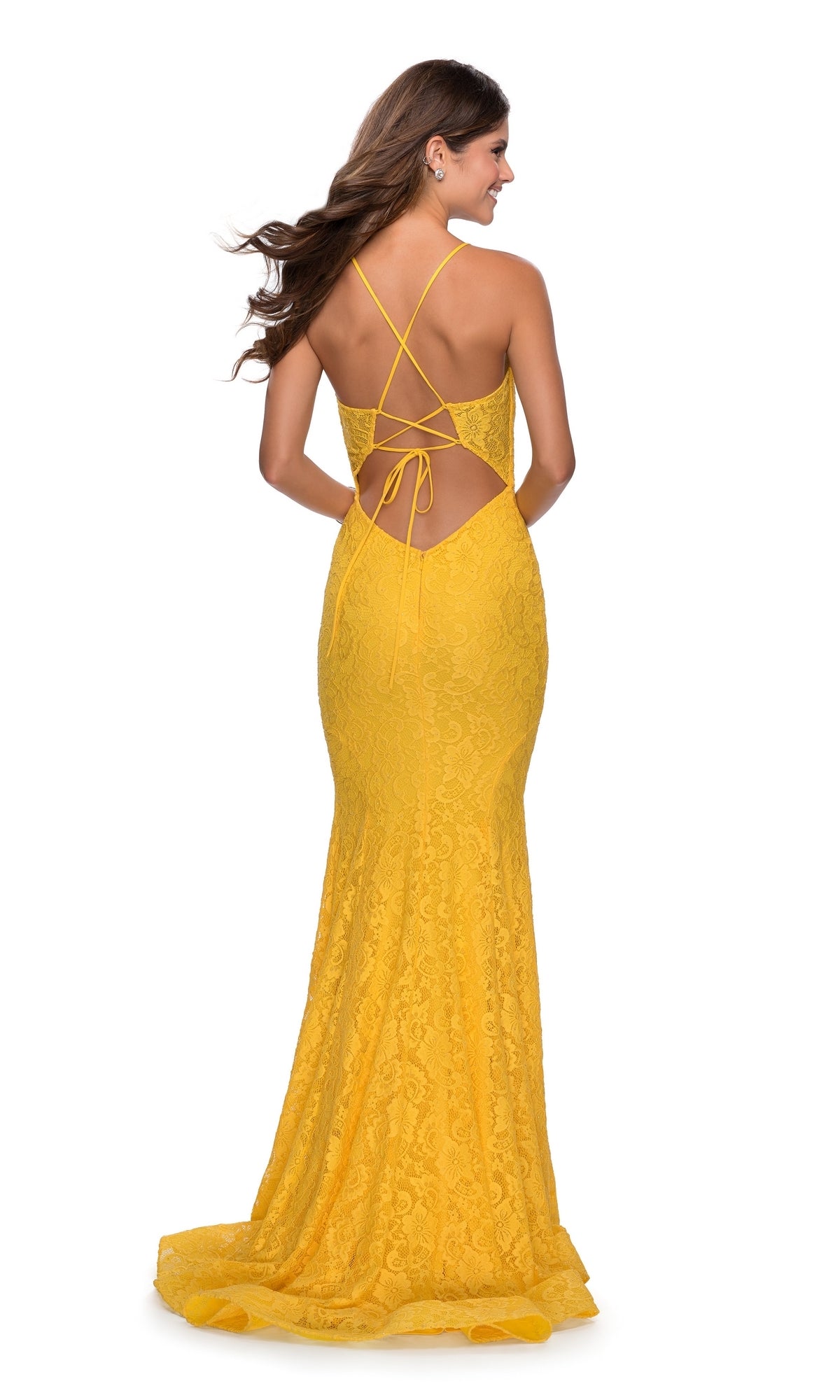 Woman facing away in the La Femme V-Neck Sheer Corset Lace Prom Dress 28591, a long yellow gown featuring an open lace-up back with crisscross straps, against a plain white background.
